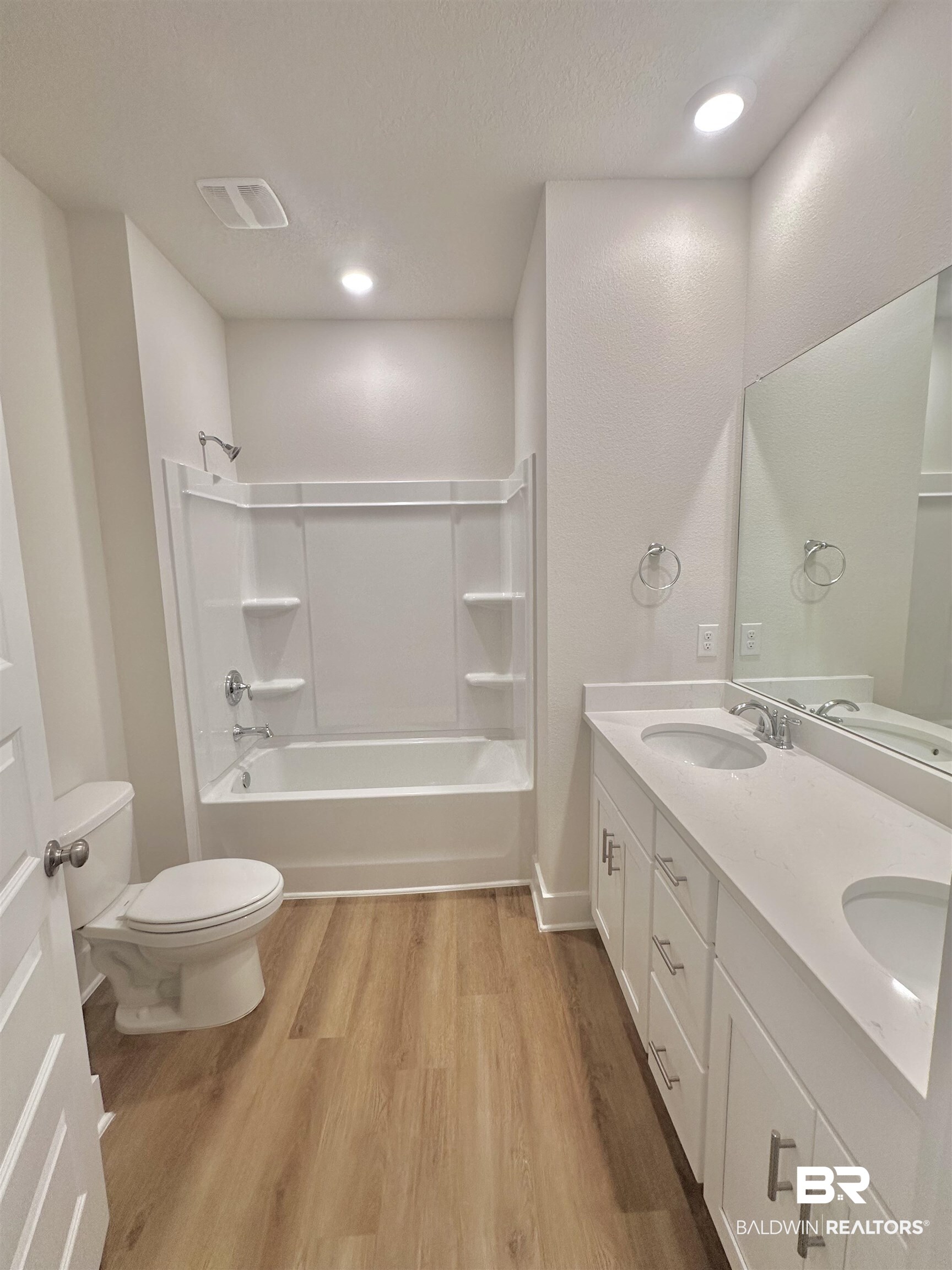 342 Barndling Street Fairhope, AL 36532 - Photo 26 of 50 Full bathroom with toilet, vanity, wood-type flooring, and shower / washtub combination