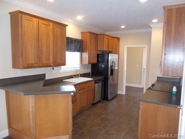 1604 Old Pardue Road Lancaster, SC 29720 - Photo 6 of 17 a kitchen with stainless steel appliances granite countertop a refrigerator a sink and a stove