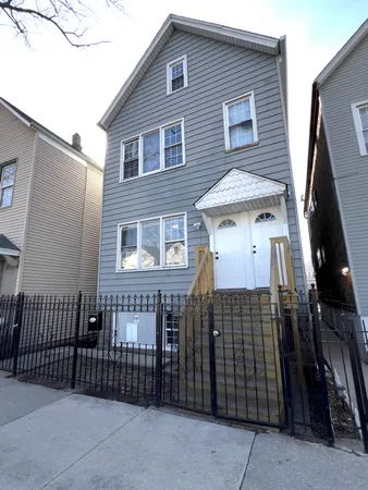 a front view of a house with iron fence