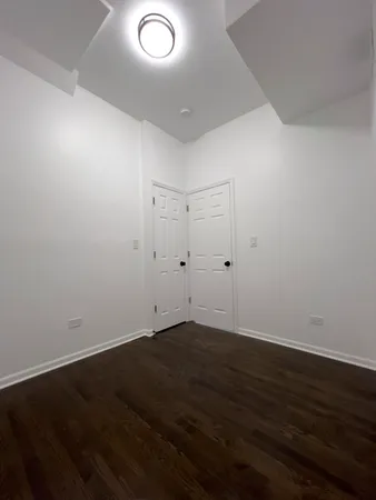 an empty room with wooden floor