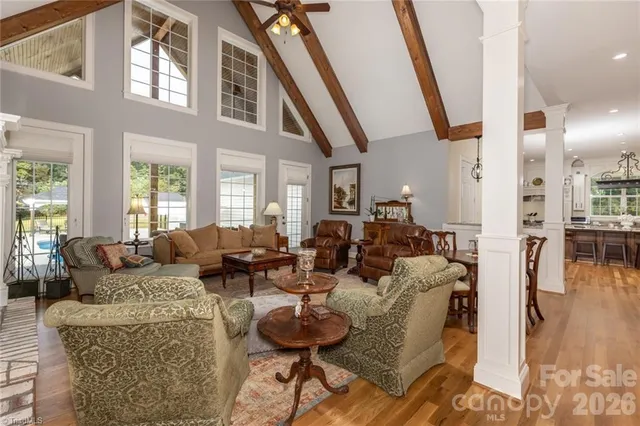 a living room with fireplace furniture and a large window