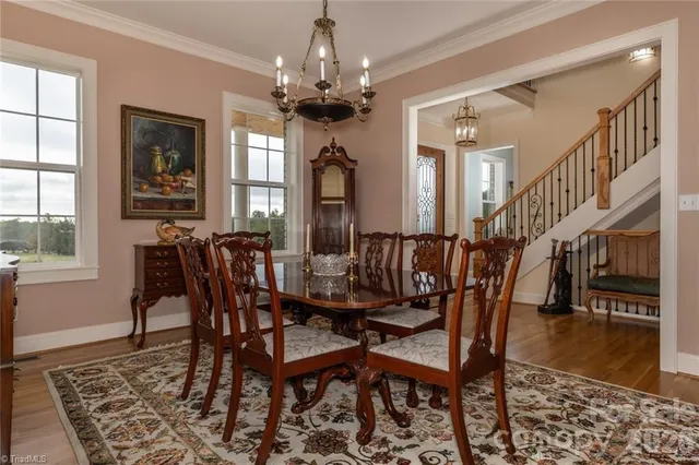 a view of a a dining room with furniture window and wooden floor