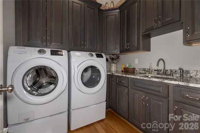 a utility room with sink dryer and washer