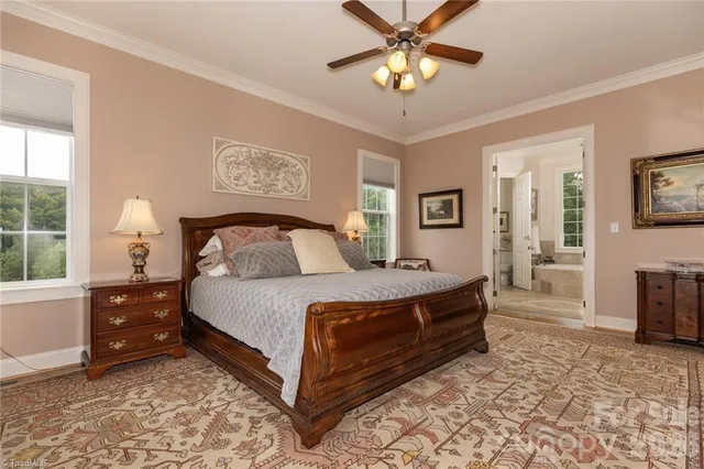 a spacious bedroom with a bed and a chandelier