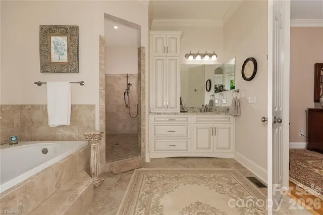a bathroom with a tub sink and mirror