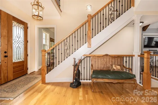 a view of entryway and hall with wooden floor
