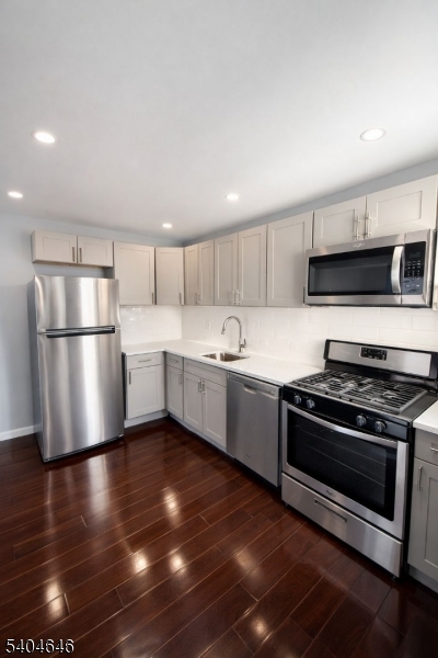 28 Treptow Street, Unit 2 Little Ferry, NJ 07643 - Photo 1 of 8 a kitchen with stainless steel appliances a stove a sink and a refrigerator