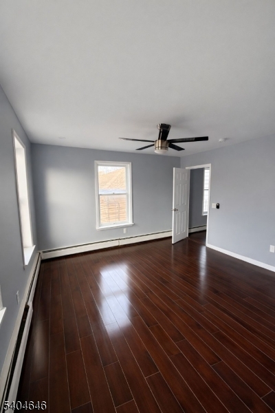 28 Treptow Street, Unit 2 Little Ferry, NJ 07643 - Photo 4 of 8 an empty room with wooden floor cabinet and windows