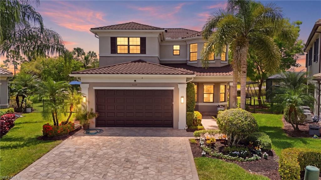 a front view of a house with a yard and garage