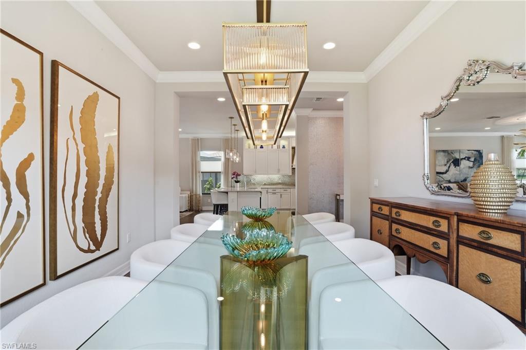 4220 Amelia Way Naples, FL 34119 - Photo 16 of 50 a living room with furniture a chandelier and a dining table