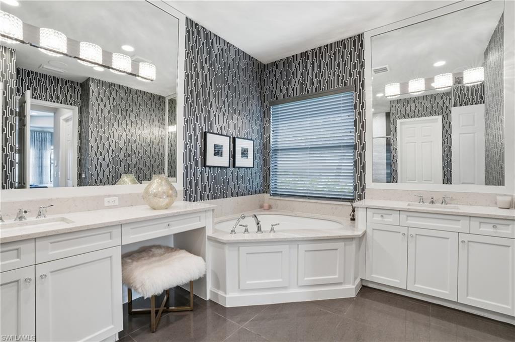 4220 Amelia Way Naples, FL 34119 - Photo 20 of 50 a bathroom with a sink and a mirror