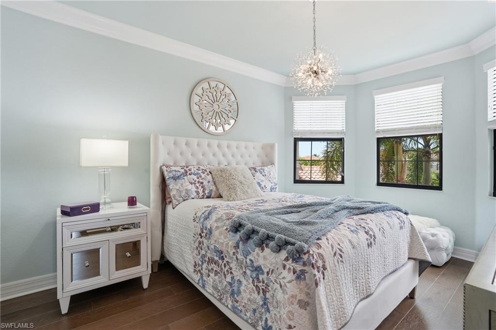 4220 Amelia Way Naples, FL 34119 - Photo 28 of 50 a bedroom with bed and a window
