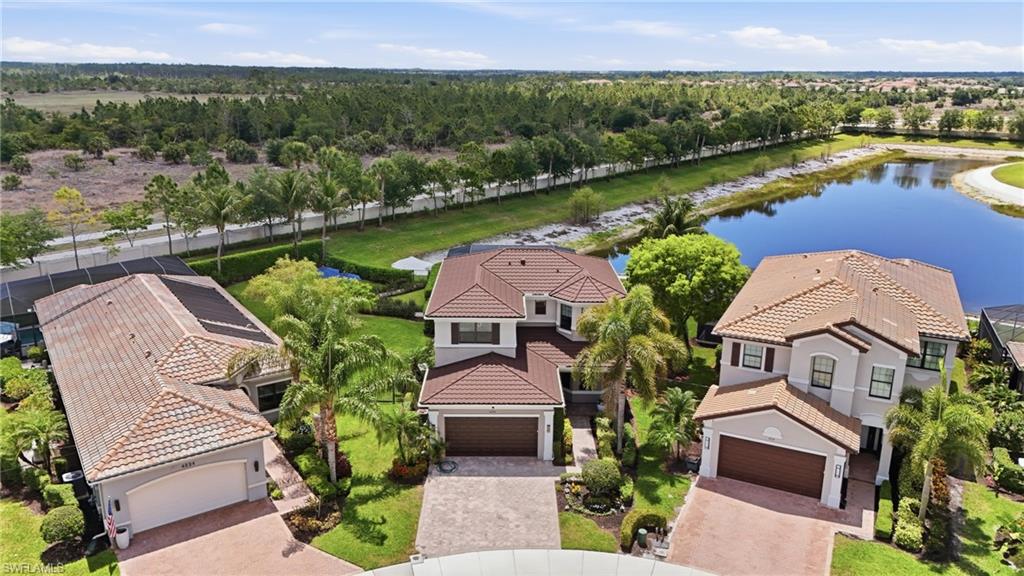 4220 Amelia Way Naples, FL 34119 - Photo 3 of 50 an aerial view of a house with a garden and lake view