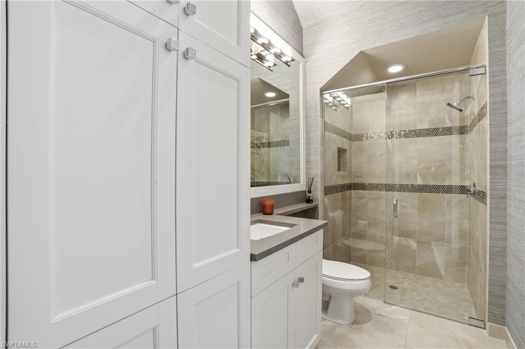 4220 Amelia Way Naples, FL 34119 - Photo 32 of 50 a bathroom with a toilet a sink and shower