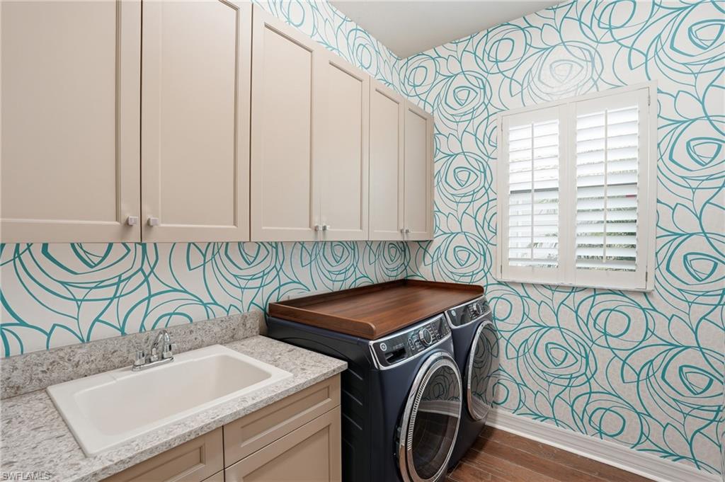 4220 Amelia Way Naples, FL 34119 - Photo 33 of 50 a utility room with multiple dryer and washer