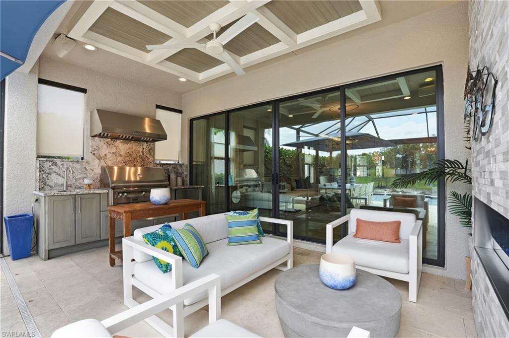 4220 Amelia Way Naples, FL 34119 - Photo 34 of 50 a living room with furniture and a large window