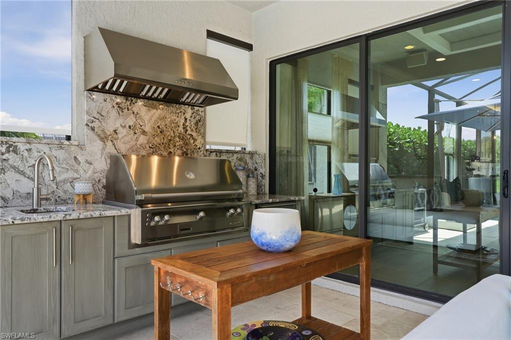 4220 Amelia Way Naples, FL 34119 - Photo 37 of 50 a kitchen with a stove and a table