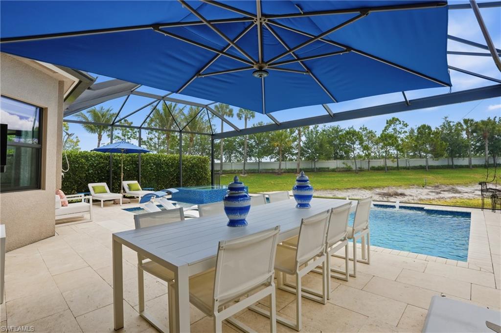 4220 Amelia Way Naples, FL 34119 - Photo 38 of 50 a view of an outdoor space with swimming pool and furniture