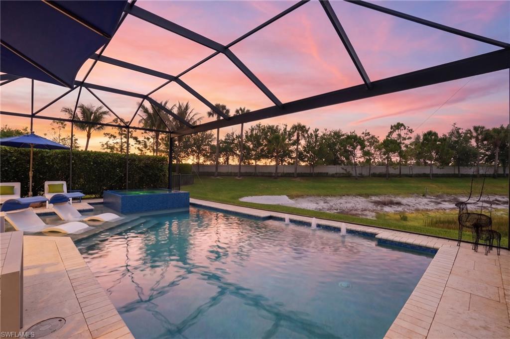 4220 Amelia Way Naples, FL 34119 - Photo 39 of 50 a view of swimming pool with a patio and a yard