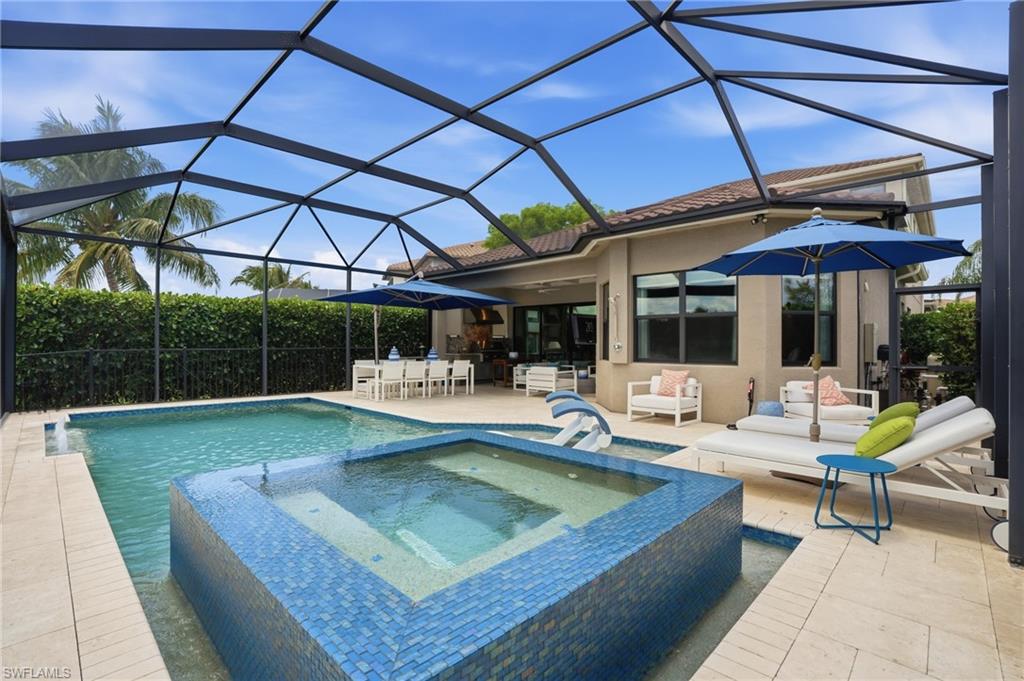 4220 Amelia Way Naples, FL 34119 - Photo 41 of 50 a view of a backyard with swimming pool and sitting area