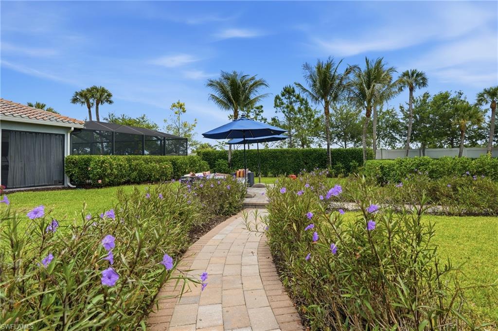 4220 Amelia Way Naples, FL 34119 - Photo 43 of 50 a view of a garden with flowers and flowers