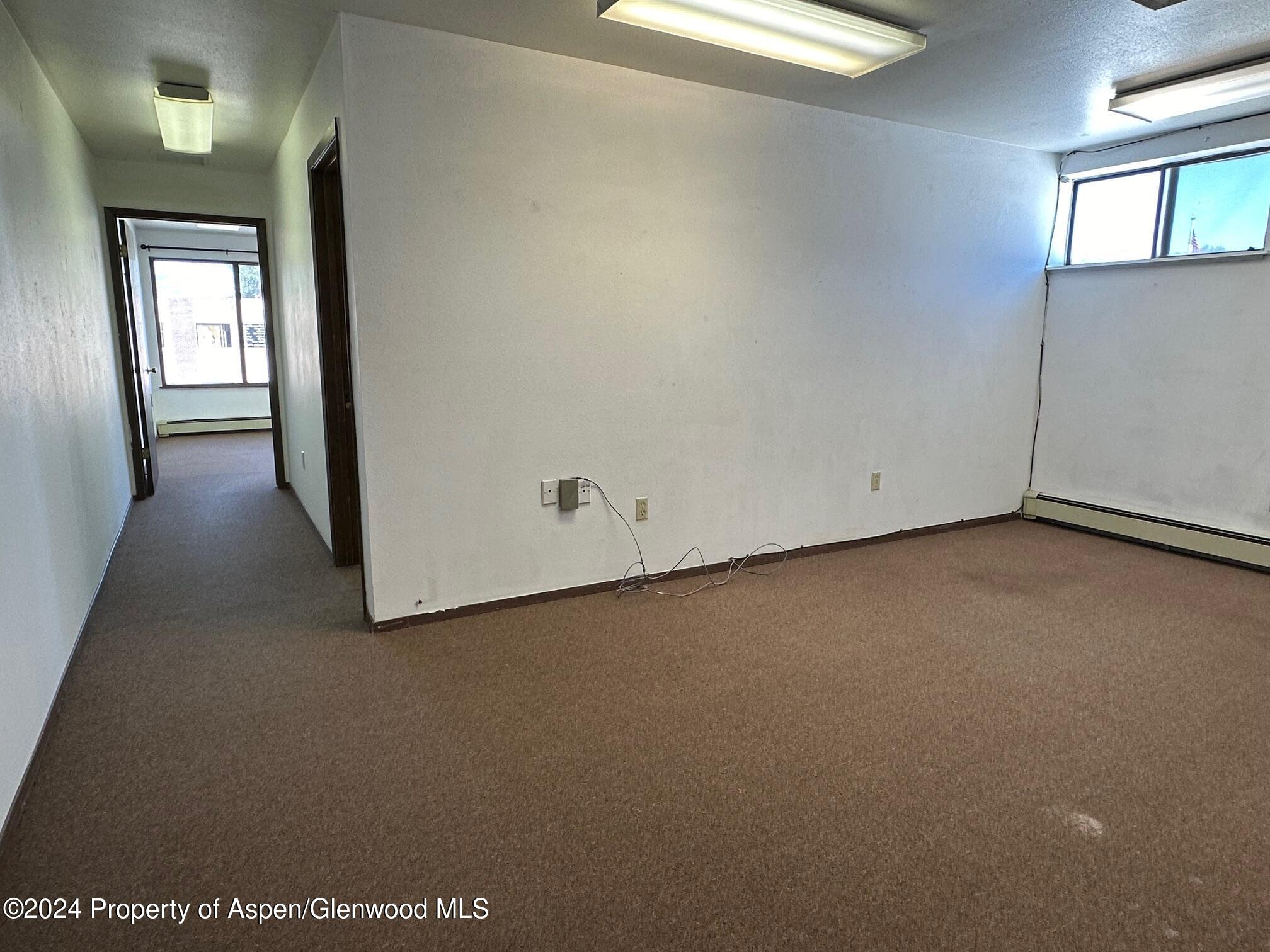 125 West 4th Street, Unit 210 Rifle, CO 81650 - Photo 8 of 8 an empty room with windows