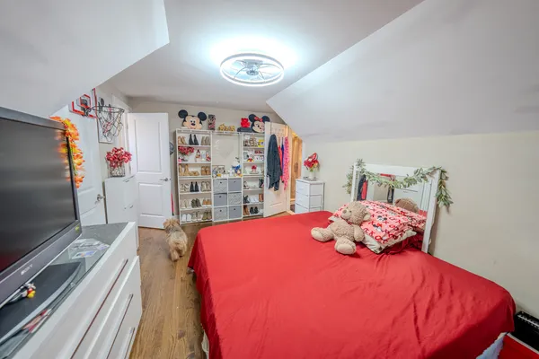 a bedroom with a bed and a flat screen tv