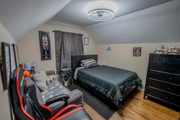 a bedroom with a bed and a chandelier