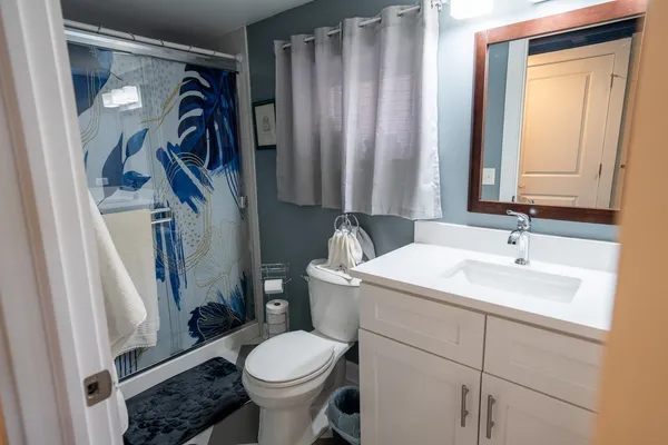 a bathroom with a sink toilet and shower