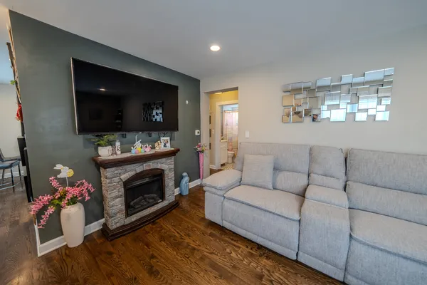 a living room with furniture a flat screen tv and a fireplace