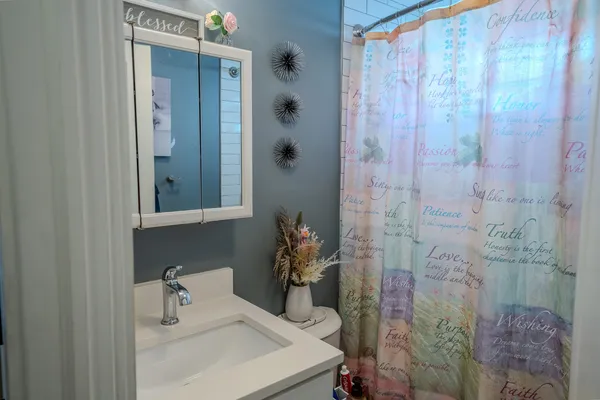 a bathroom with a sink and mirror