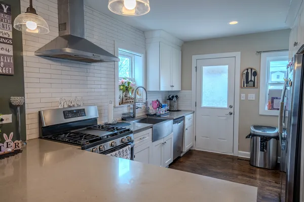 a kitchen with granite countertop a stove and a refrigerator