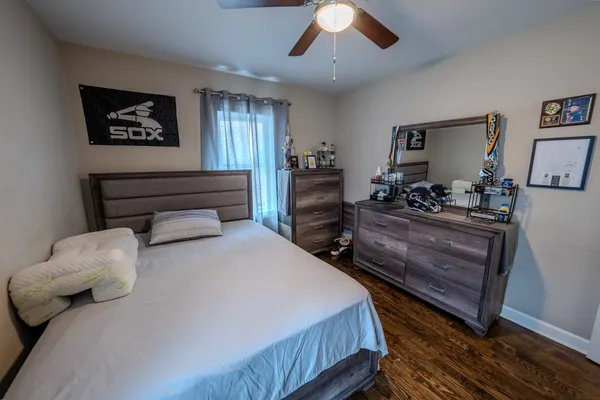 a bedroom with a bed and a chandelier