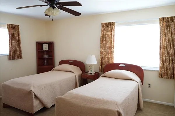 a bedroom with two beds and painting on the wall