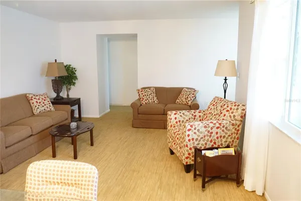 a living room with furniture and a lamp