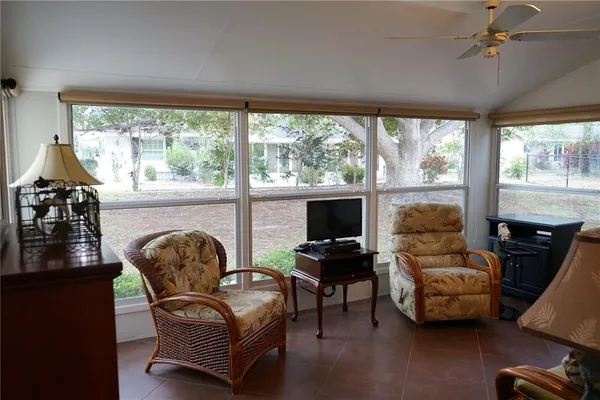 a living room with furniture and a floor to ceiling window