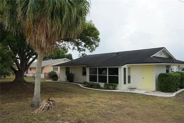 a front view of a house with a garden and yard