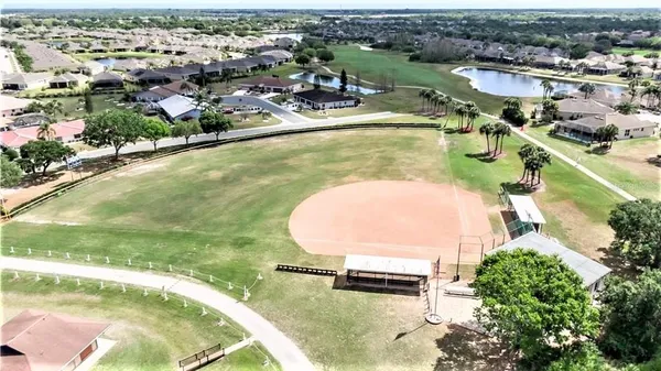 an aerial view of a swimming pool with a yard
