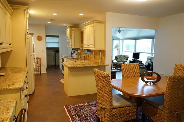 a living room with fireplace furniture and a large window