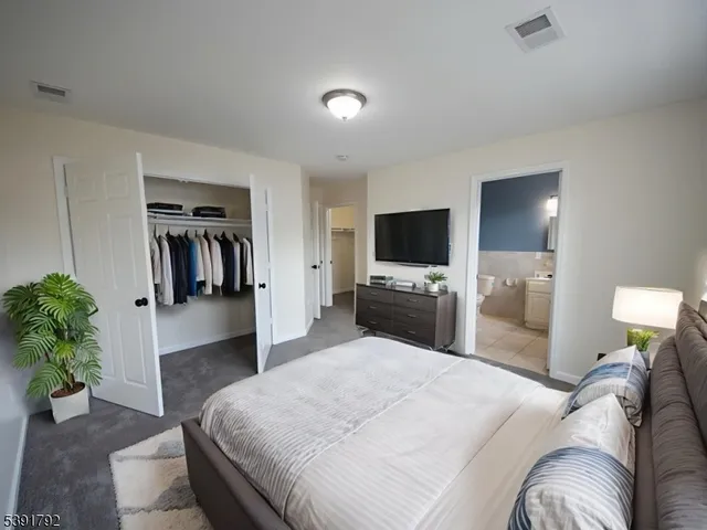 a bedroom with a bed and a television