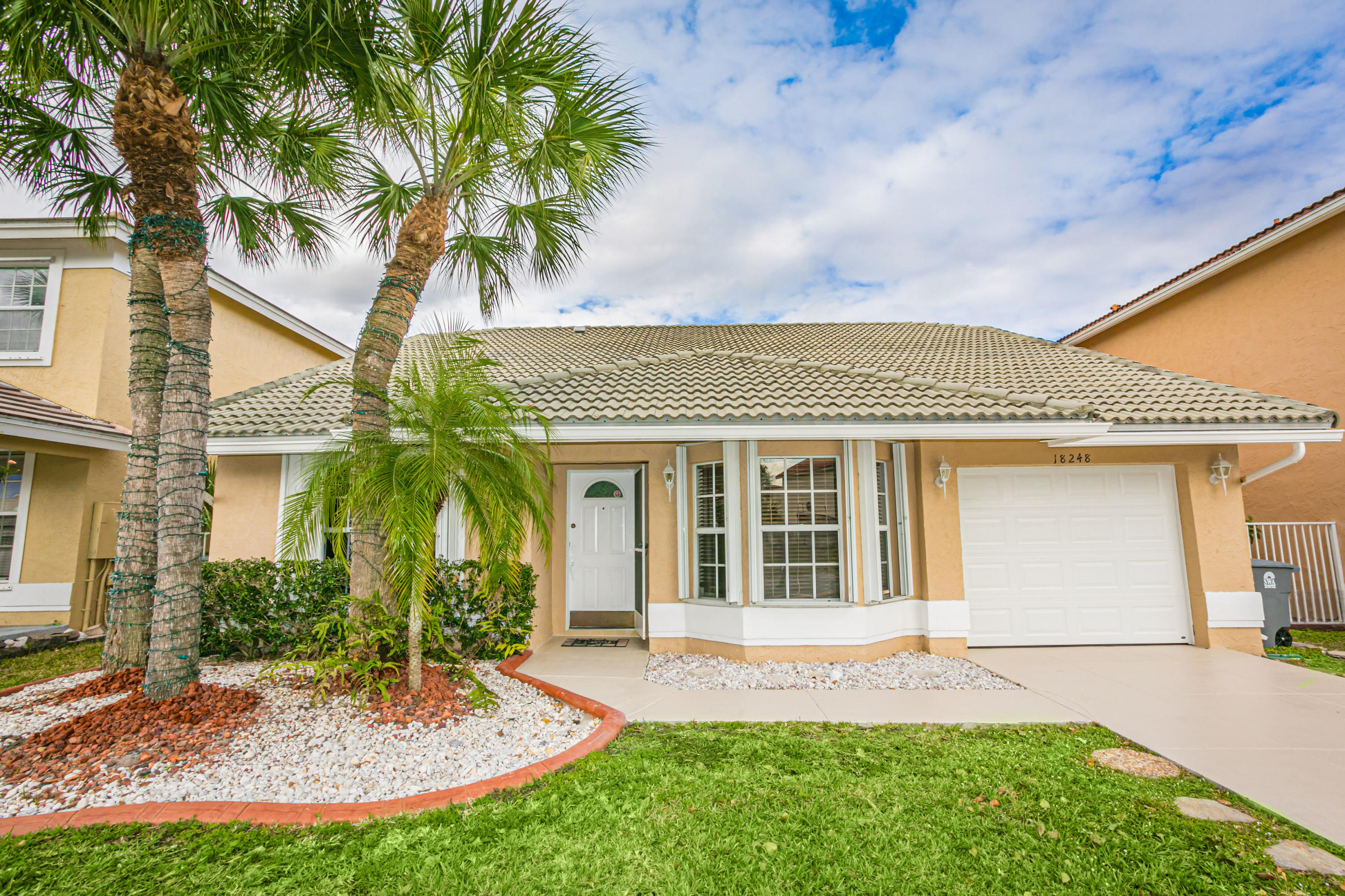 18248 Clear Brook Circle Boca Raton, FL 33498 - Photo 1 of 26 front view of a house with a yard