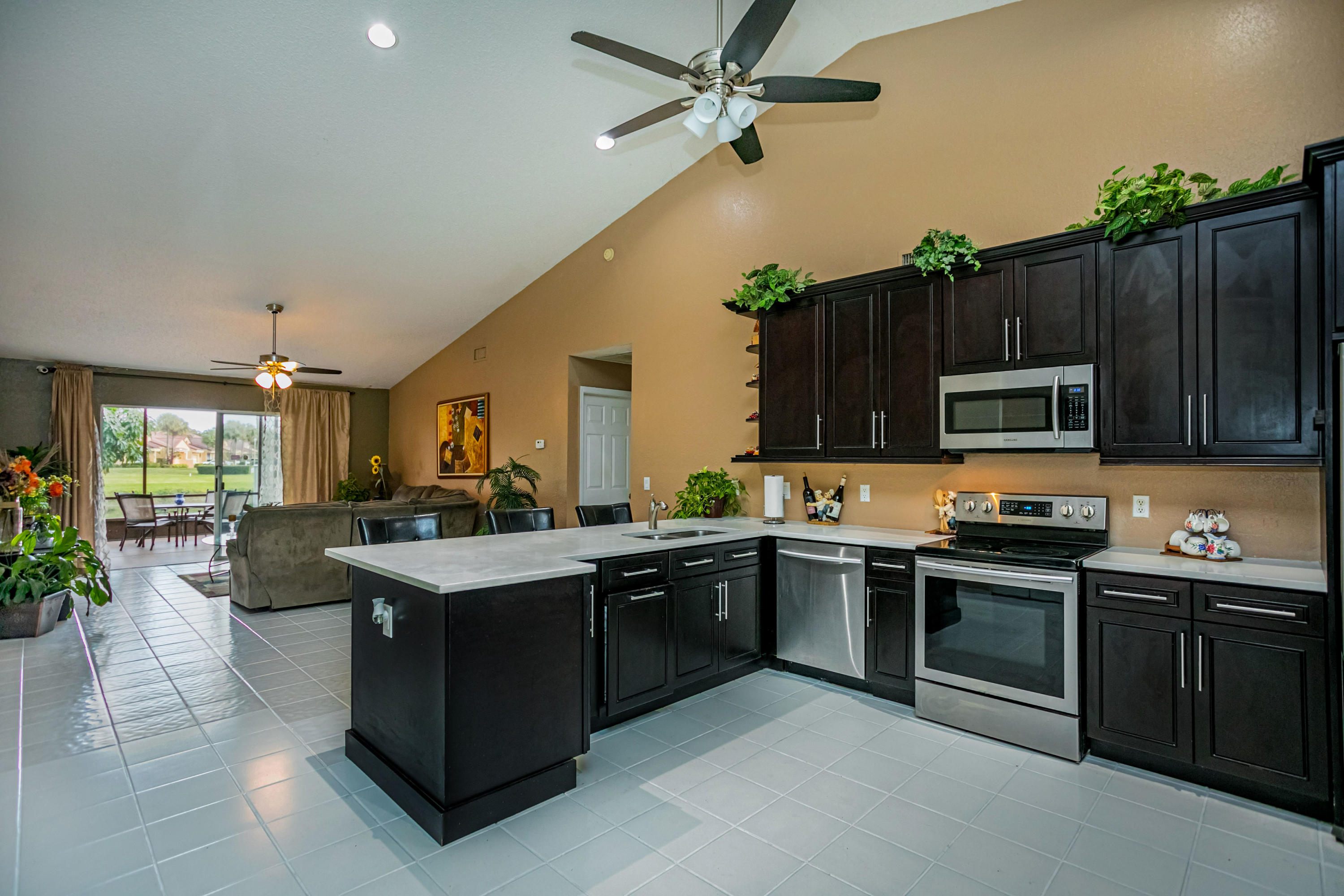 18248 Clear Brook Circle Boca Raton, FL 33498 - Photo 14 of 26 a kitchen with a sink stainless steel appliances and cabinets