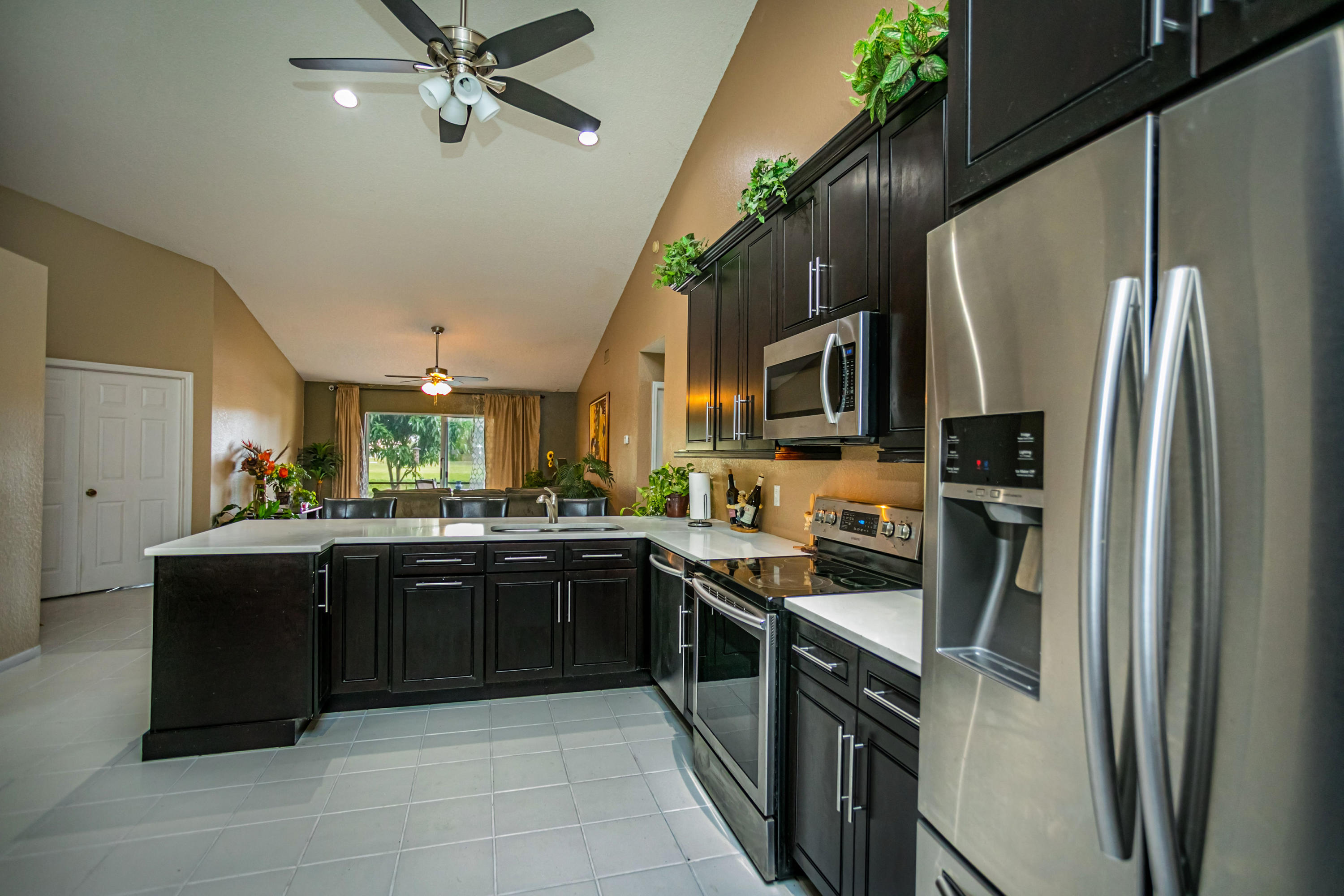 18248 Clear Brook Circle Boca Raton, FL 33498 - Photo 15 of 26 a kitchen with stainless steel appliances granite countertop refrigerator a sink a stove top oven and a dishwasher