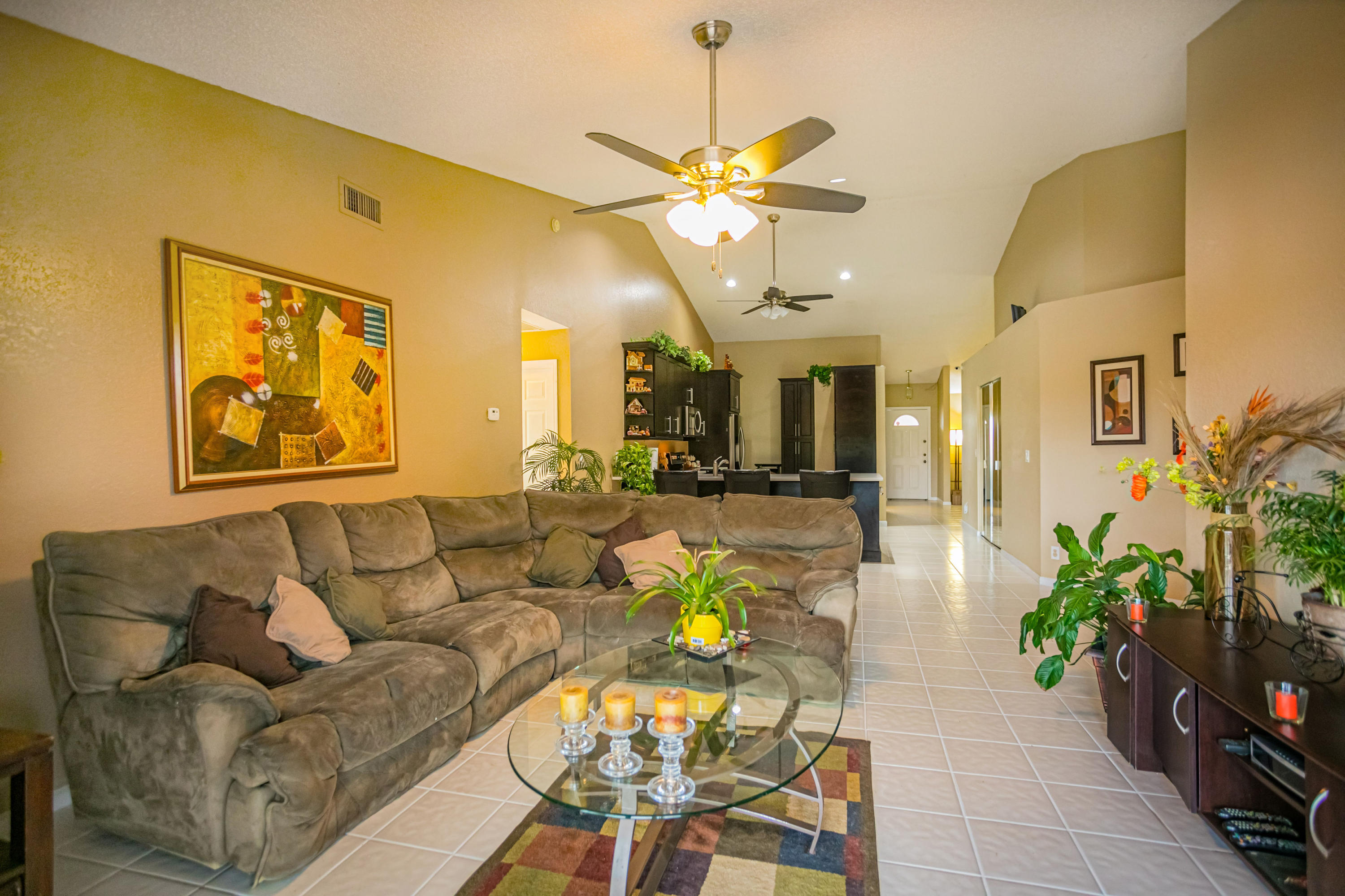 18248 Clear Brook Circle Boca Raton, FL 33498 - Photo 18 of 26 a living room with furniture a chandelier and a dining table