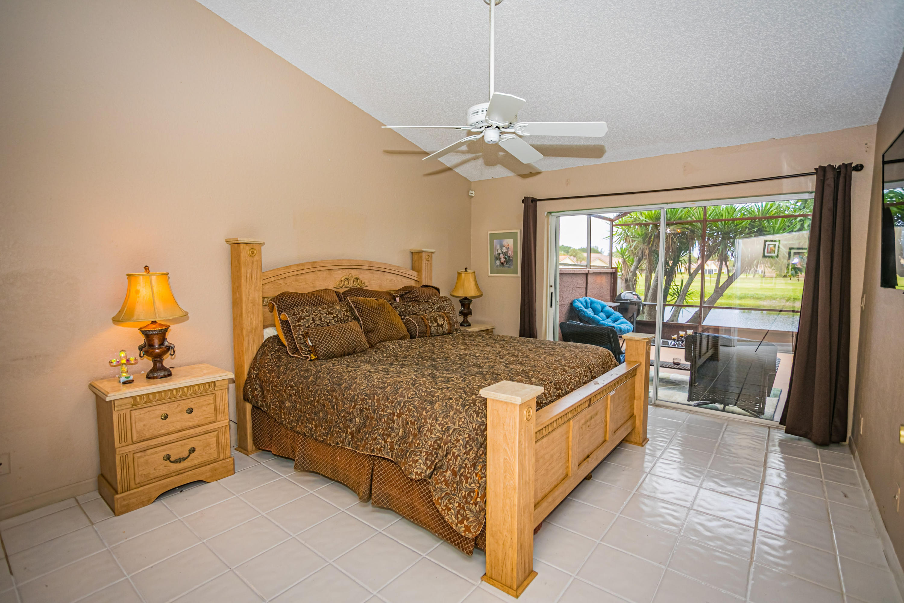 18248 Clear Brook Circle Boca Raton, FL 33498 - Photo 23 of 26 a bedroom with a bed and a chandelier