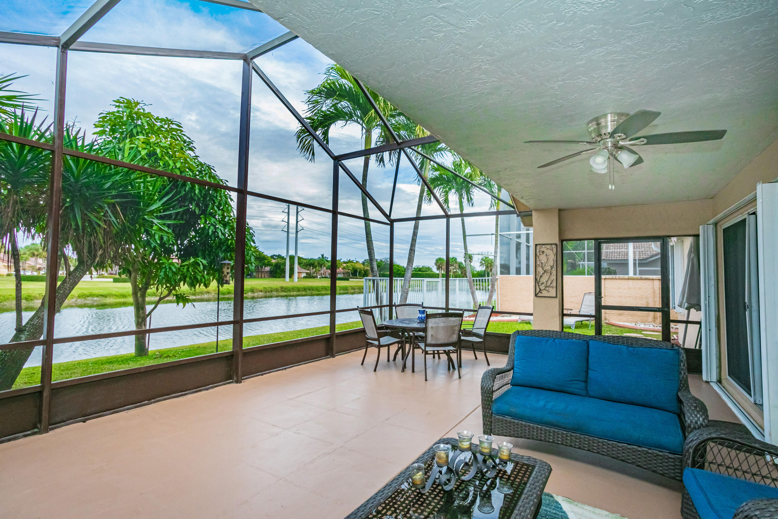 18248 Clear Brook Circle Boca Raton, FL 33498 - Photo 7 of 26 a living room filled with furniture and a chandelier