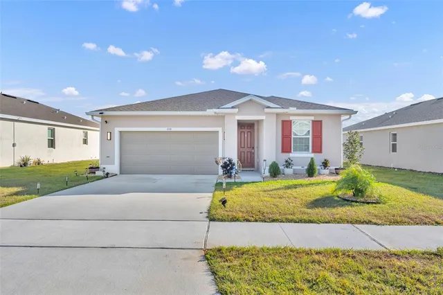 a front view of house with yard seating and garage