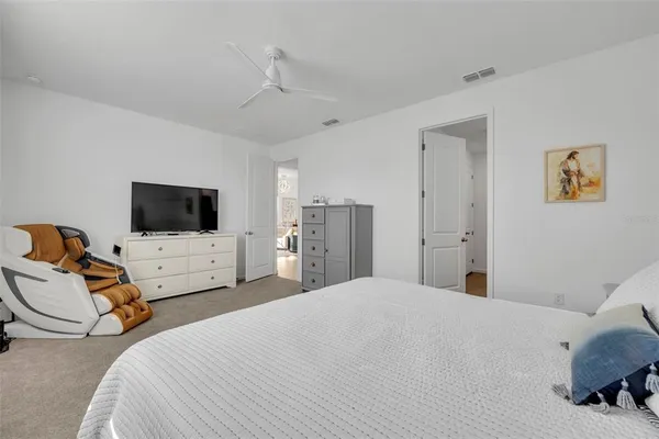 a bedroom with bed tv and view of room