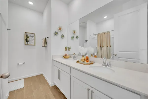 a hallway with sink and wooden floor