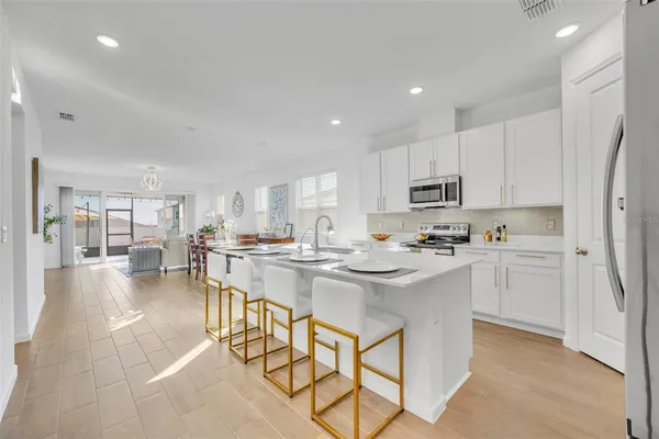 a kitchen with stainless steel appliances kitchen island granite countertop a sink and cabinets
